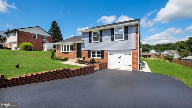 view of front of property with a garage and a front yard