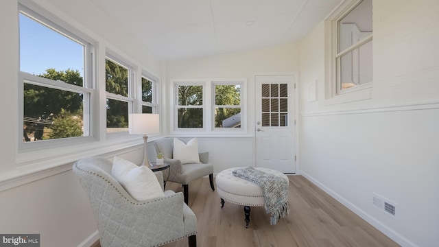 sunroom with lofted ceiling and a healthy amount of sunlight