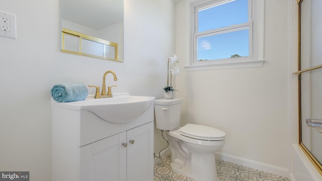 full bathroom with tile patterned floors, toilet, bath / shower combo with glass door, and vanity