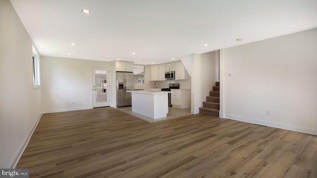 unfurnished living room with wood-type flooring