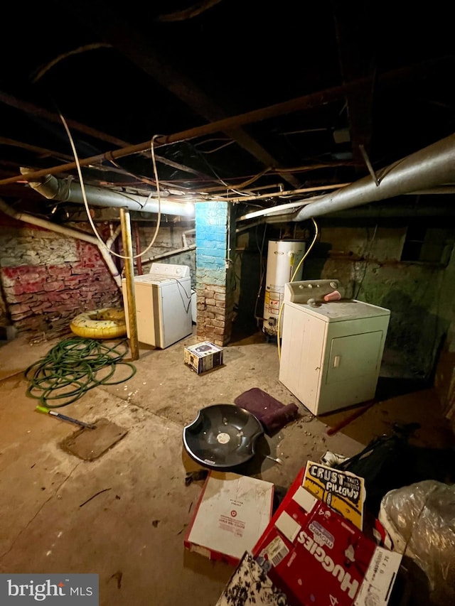 basement featuring washing machine and dryer and gas water heater