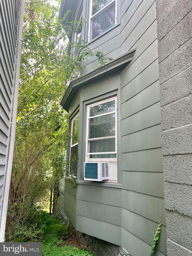 view of side of home featuring cooling unit