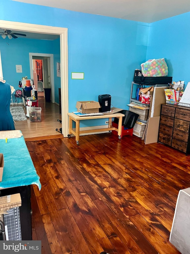 interior space featuring ceiling fan and dark wood-type flooring