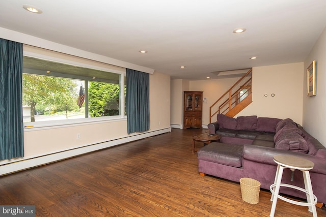 living room featuring a baseboard heating unit and hardwood / wood-style floors