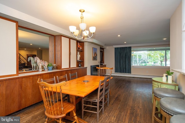 dining area featuring baseboard heating, dark wood-type flooring, and a chandelier