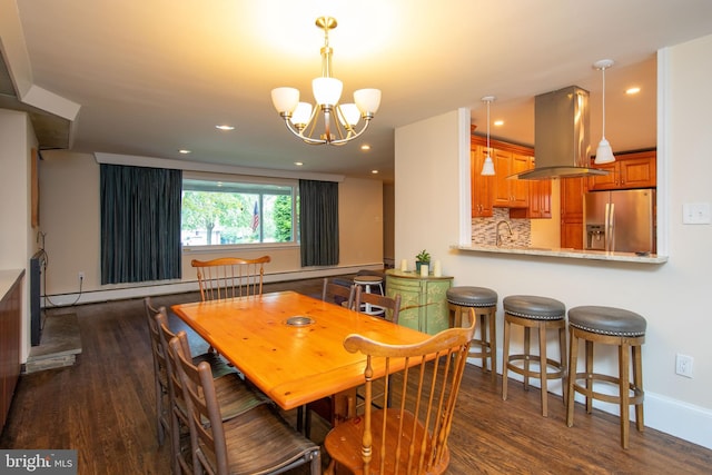 dining room featuring sink, dark wood-type flooring, and an inviting chandelier