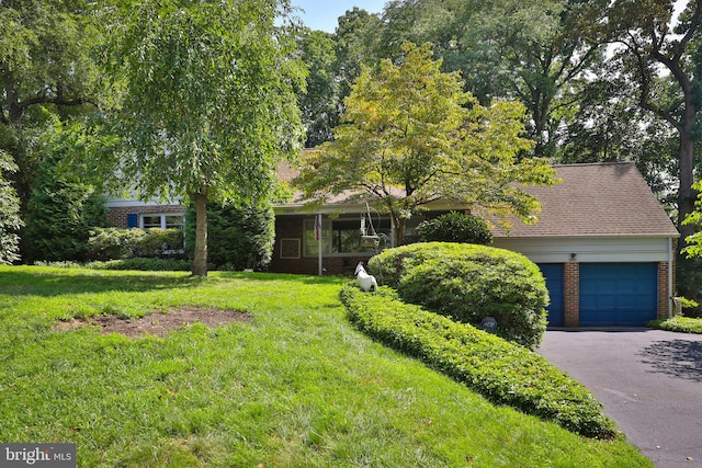 view of front of home with a garage and a front yard