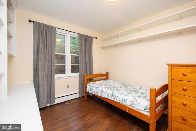 bedroom featuring a baseboard radiator and dark hardwood / wood-style flooring