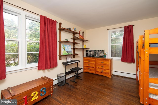 miscellaneous room featuring plenty of natural light, dark wood-type flooring, and a baseboard heating unit