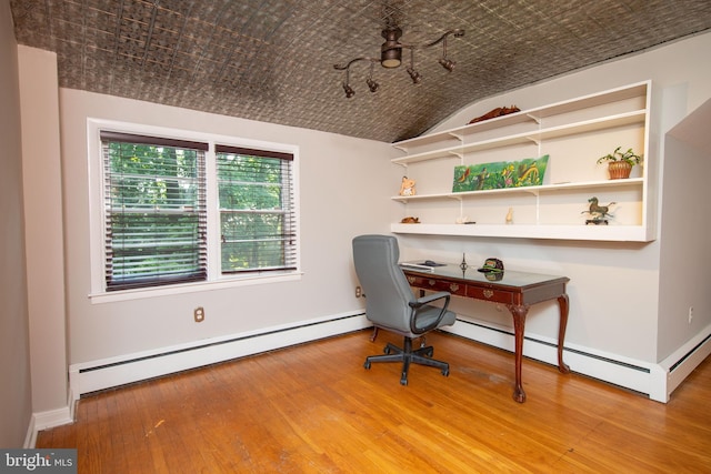 home office featuring light wood-type flooring, lofted ceiling, and a baseboard radiator