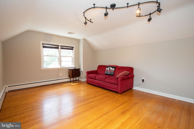 sitting room featuring vaulted ceiling, light hardwood / wood-style floors, track lighting, and a baseboard radiator