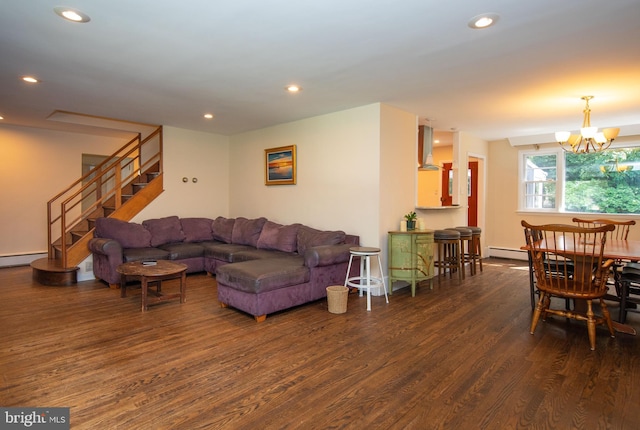 living room featuring a baseboard heating unit, dark wood-type flooring, and an inviting chandelier