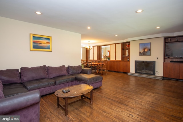 living room with a notable chandelier and dark hardwood / wood-style floors