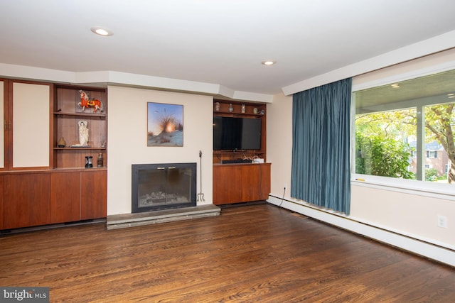 unfurnished living room with dark hardwood / wood-style floors and a baseboard radiator