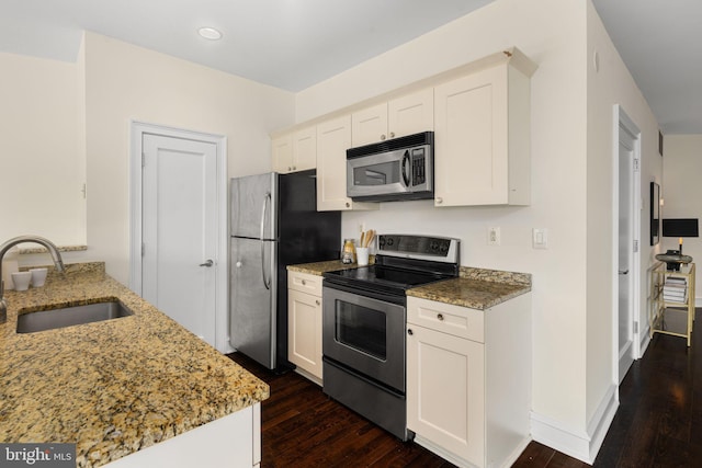 kitchen featuring sink, white cabinetry, appliances with stainless steel finishes, and dark hardwood / wood-style floors