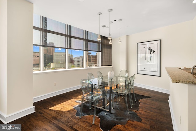 dining space featuring dark hardwood / wood-style floors