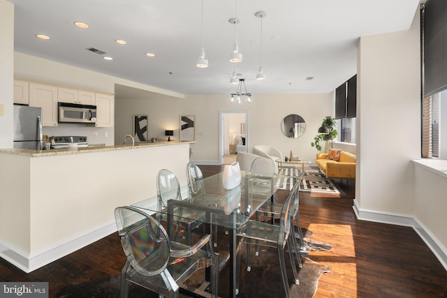 dining area with dark hardwood / wood-style floors