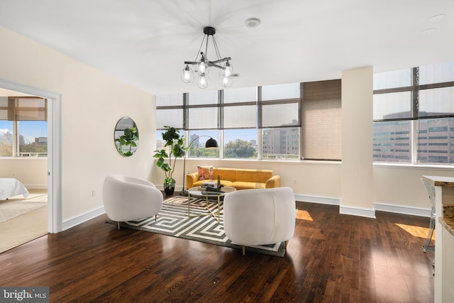 living room featuring hardwood / wood-style flooring, a notable chandelier, and plenty of natural light