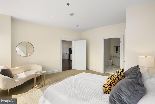 carpeted bedroom featuring ensuite bath