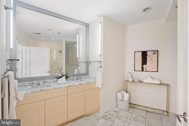 bathroom with double vanity, tile patterned floors, and a tile shower