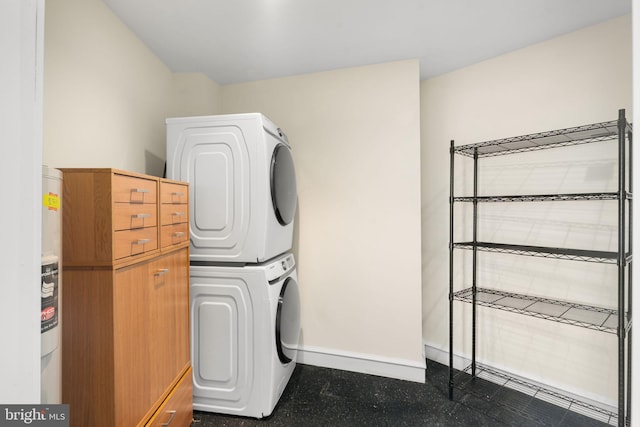 clothes washing area featuring stacked washer and clothes dryer