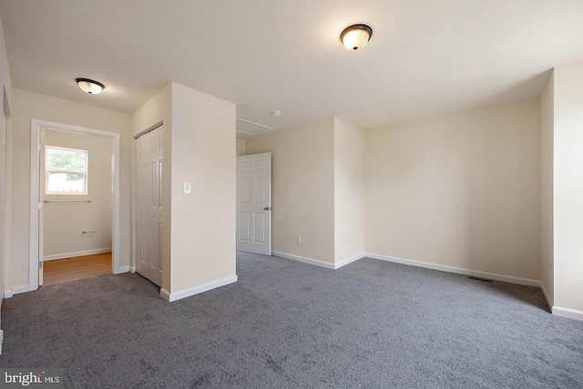 unfurnished bedroom with dark carpet