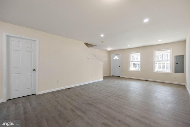 empty room with hardwood / wood-style floors and electric panel