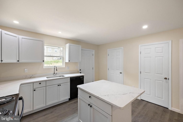kitchen with white cabinets, sink, a kitchen island, and black appliances