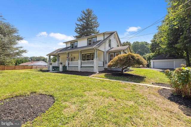 exterior space with a garage, an outbuilding, a porch, and a front yard