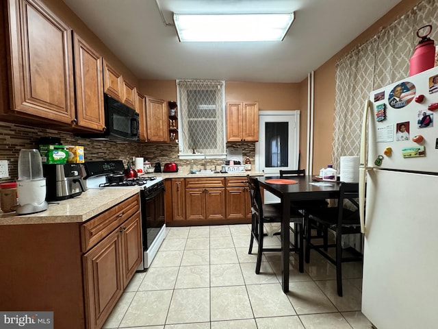 kitchen with backsplash, white appliances, and light tile patterned floors