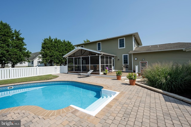 view of pool featuring a sunroom and a patio