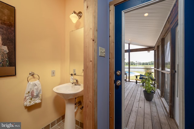 bathroom with vaulted ceiling and hardwood / wood-style floors