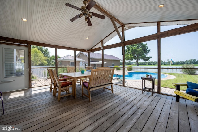 sunroom featuring ceiling fan and lofted ceiling