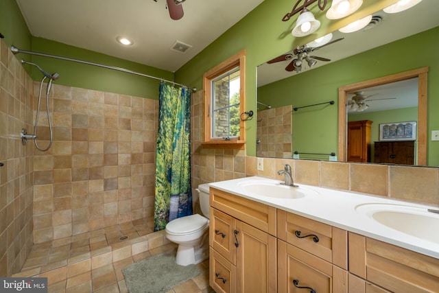 bathroom featuring double vanity, tile walls, ceiling fan, toilet, and walk in shower