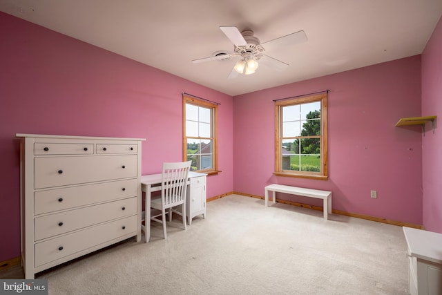 carpeted home office featuring ceiling fan