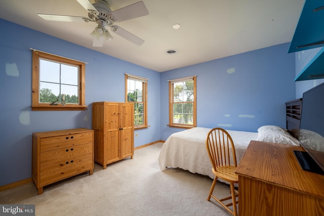 bedroom with ceiling fan and light carpet