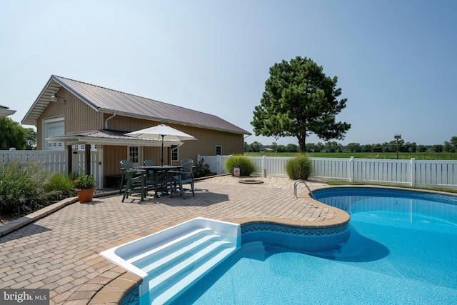 view of swimming pool featuring a patio