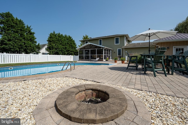 view of swimming pool with an outdoor fire pit and a patio