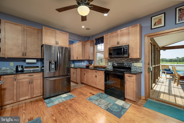 kitchen with a wealth of natural light, ceiling fan, light hardwood / wood-style flooring, and stainless steel appliances