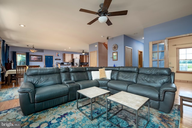 living room with ceiling fan and hardwood / wood-style flooring