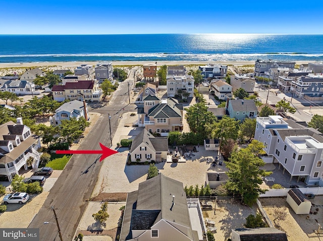 aerial view with a water view and a view of the beach