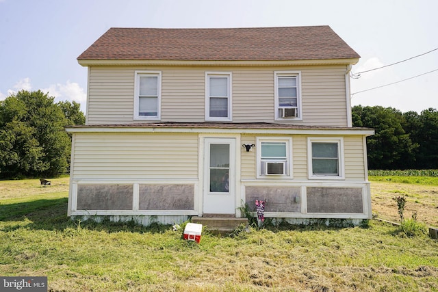 rear view of property featuring a yard