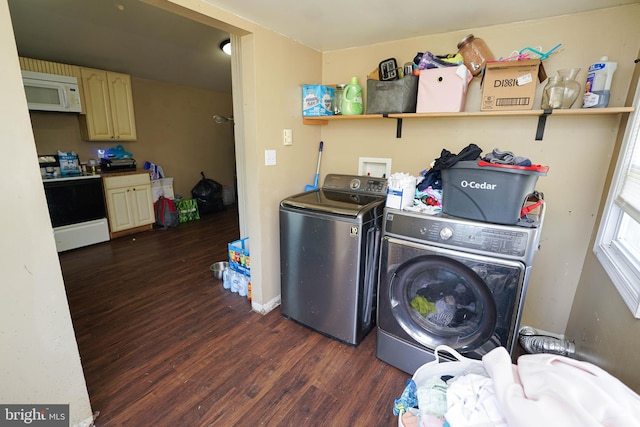 clothes washing area with dark hardwood / wood-style flooring and separate washer and dryer