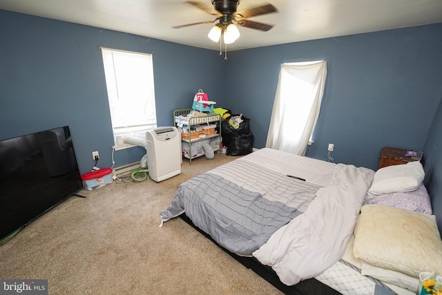 bedroom with ceiling fan and light colored carpet