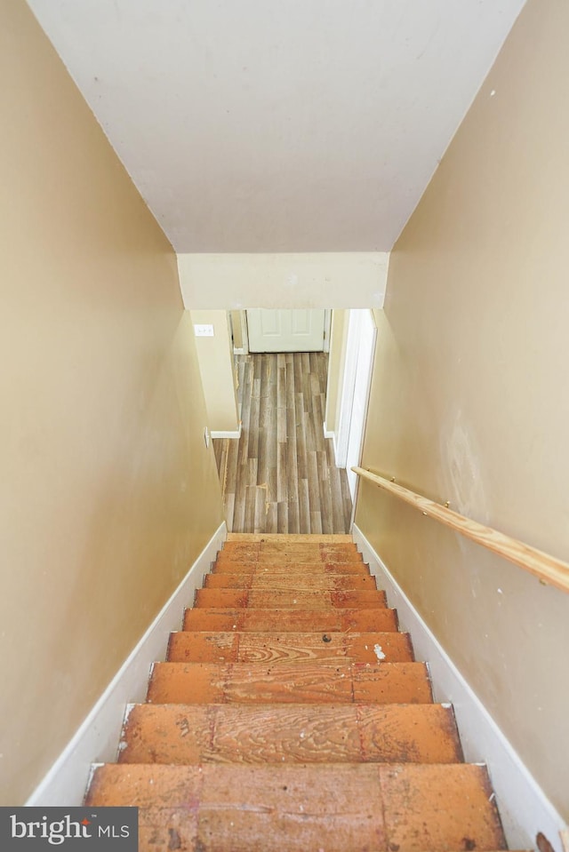 stairway featuring hardwood / wood-style floors