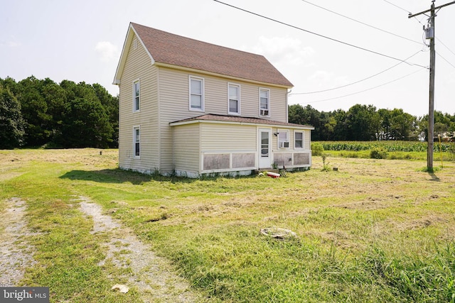 rear view of house with a lawn