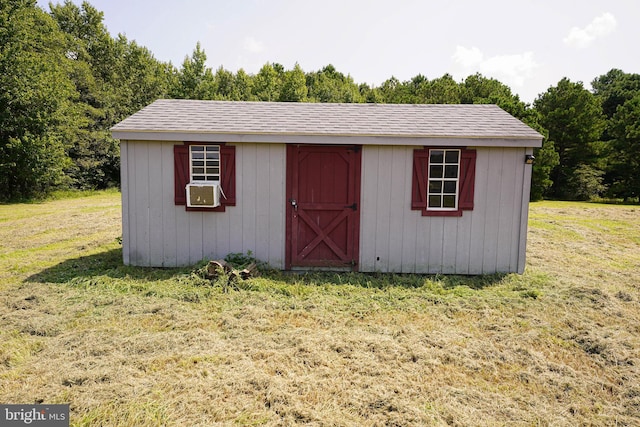 view of outbuilding featuring a lawn