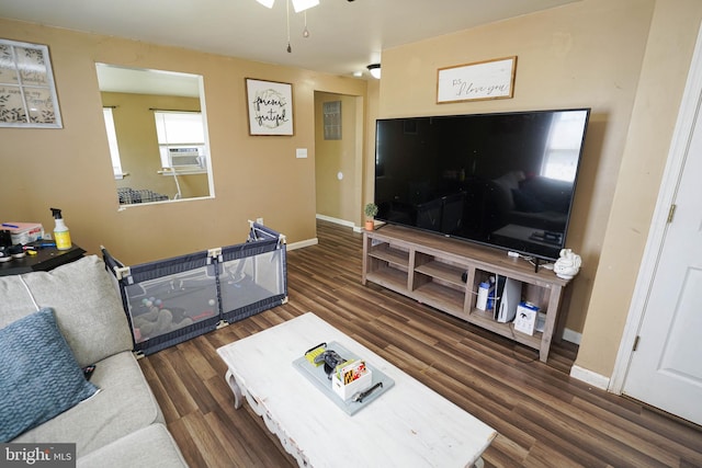 living room featuring ceiling fan, cooling unit, and dark hardwood / wood-style floors