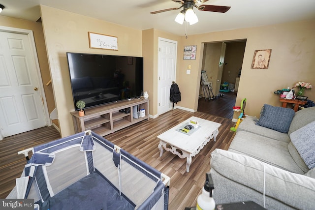 living room featuring ceiling fan and wood-type flooring