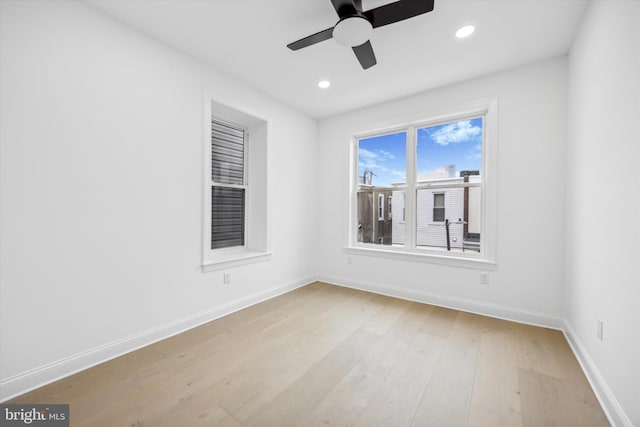 spare room with recessed lighting, baseboards, and light wood finished floors